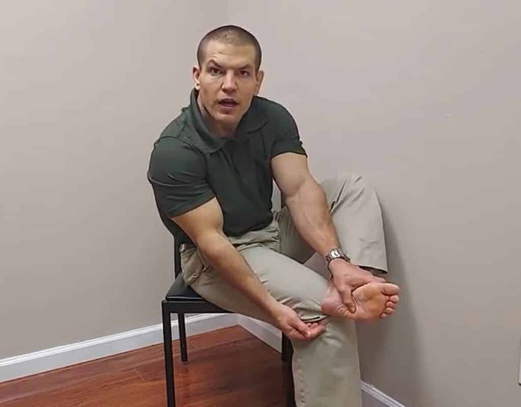 holding thumb over cuboid bone from backside, stretch for pain on outside of foot