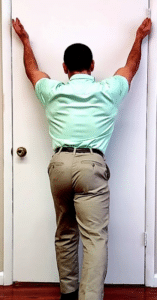 standing facing wall lower trapezius exercise for shoulder impingement