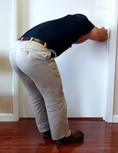 Upper back pain stretch from doorknob