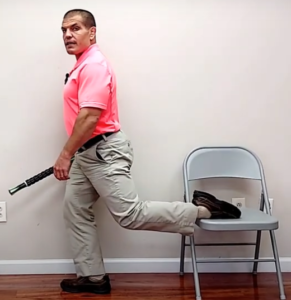 standing quad stretch with foot on chair