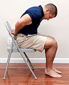 Slump test for sciatica pain behind the knee - start