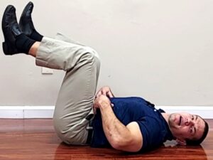 Abdominal exercise for back pain with both legs lifted knees bent